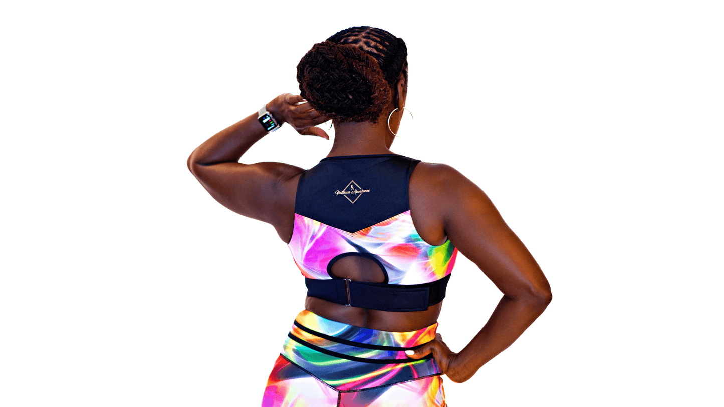 Back view of a woman in a vibrant Neon Nirvana Empress Bra, showcasing its racerback design and colorful print.